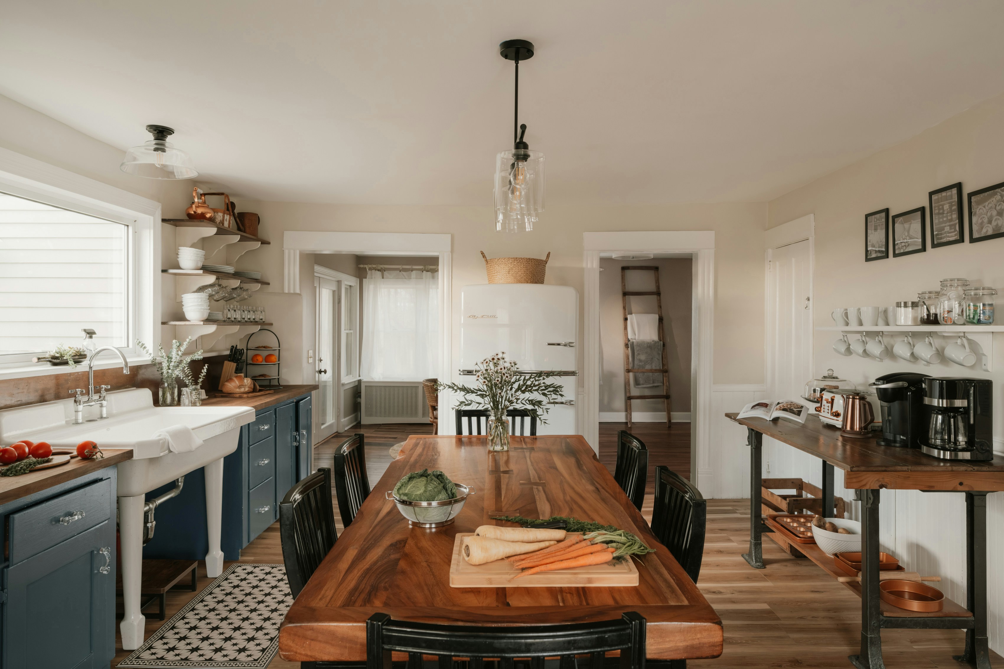 Photo of rows of books in a library with marble busts.